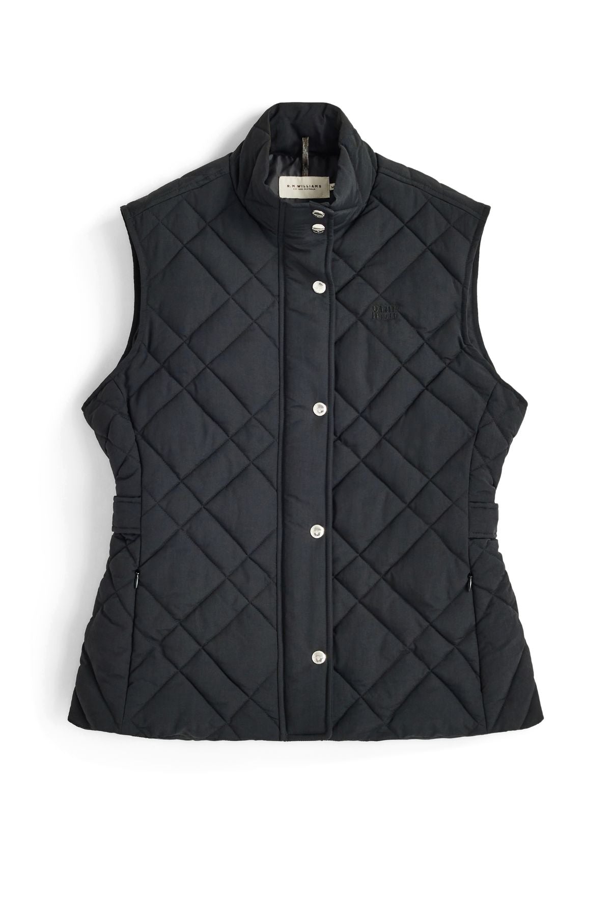 The RM Williams Ikara Vest, shown in black, is a sleeveless, quilted vest featuring snap buttons, a stand collar, and side elastic details, laid flat on a white background.