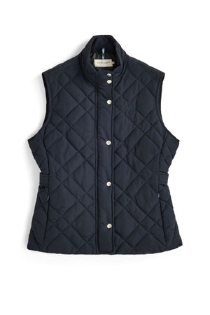 The RM Williams Ikara Vest, a sleeveless navy blue quilted vest made from recycled nylon, features silver snap buttons and a stand-up collar and is displayed laid flat on a white background.