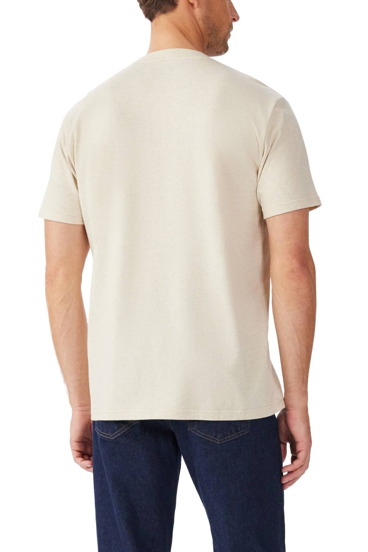 A man is seen from behind wearing the RM Williams Parson T-Shirt in light beige with a ribbed crew neck and short sleeves, paired with dark blue jeans, standing against a white background.