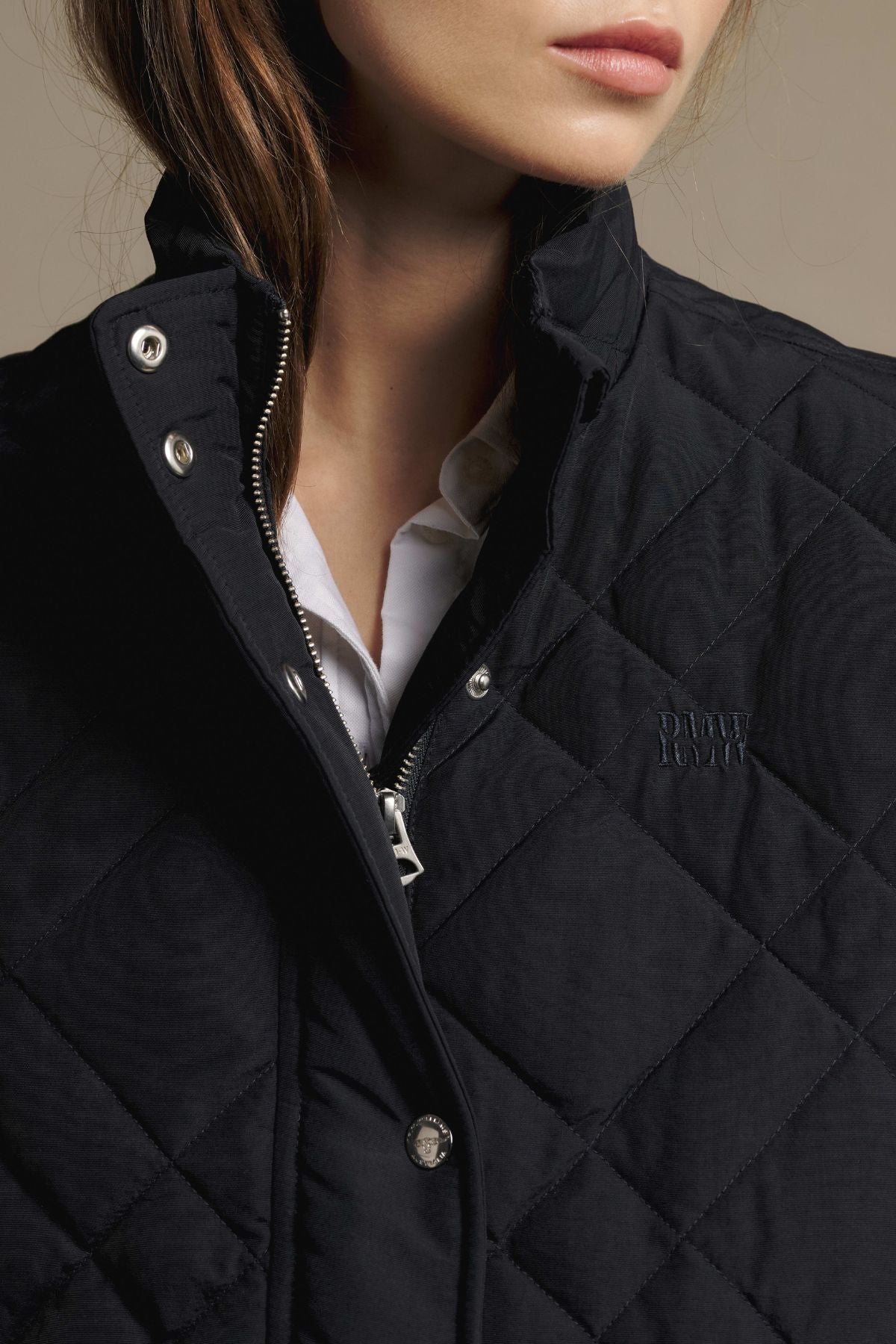 RM Williams Ikara Vest in a slim fit, black quilted style with a zippered front and high collar, worn over a white collared shirt.