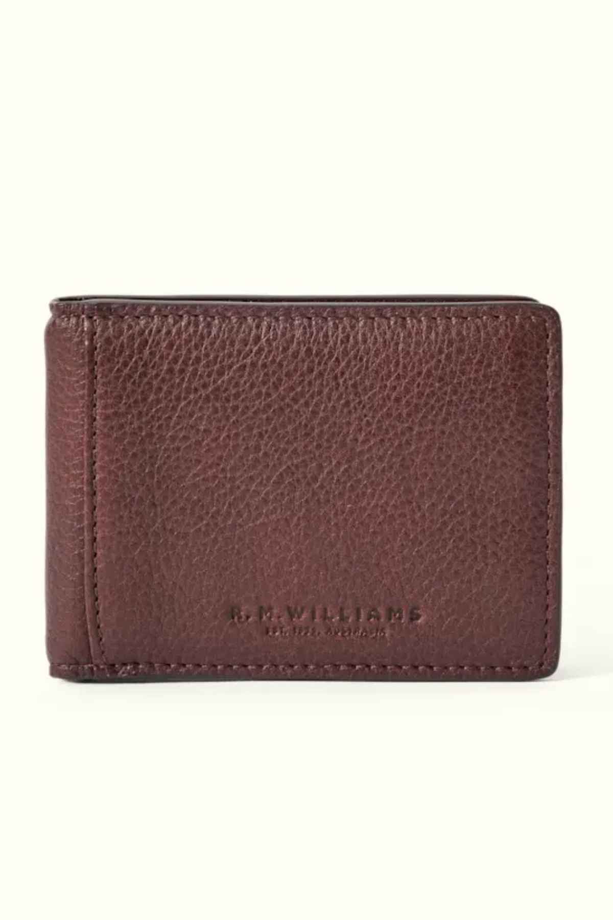 This modern RM Williams Farrier Bi-Fold Wallet is crafted from premium leather and features the "R.M. Williams" embossment on the front. Displayed closed against a plain background, it embodies timeless elegance and sophisticated style in its brown leather design.