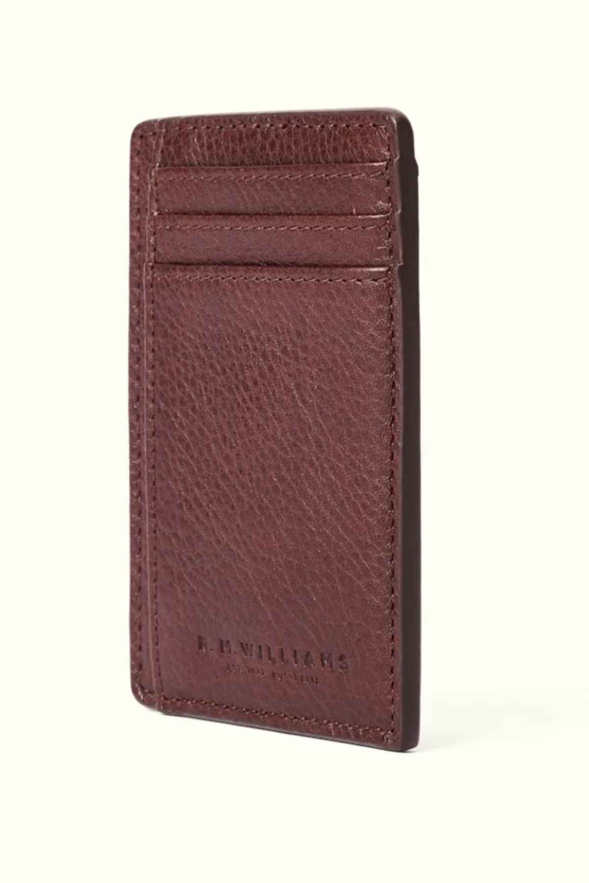 The RM Williams Farrier Cardholder with Money Clip exemplifies craftsmanship with its vertical brown leather design, textured finish, subtle embossed branding at the base, and two card slots. This premium leather accessory is ideal for individuals who appreciate both style and functionality in every aspect.