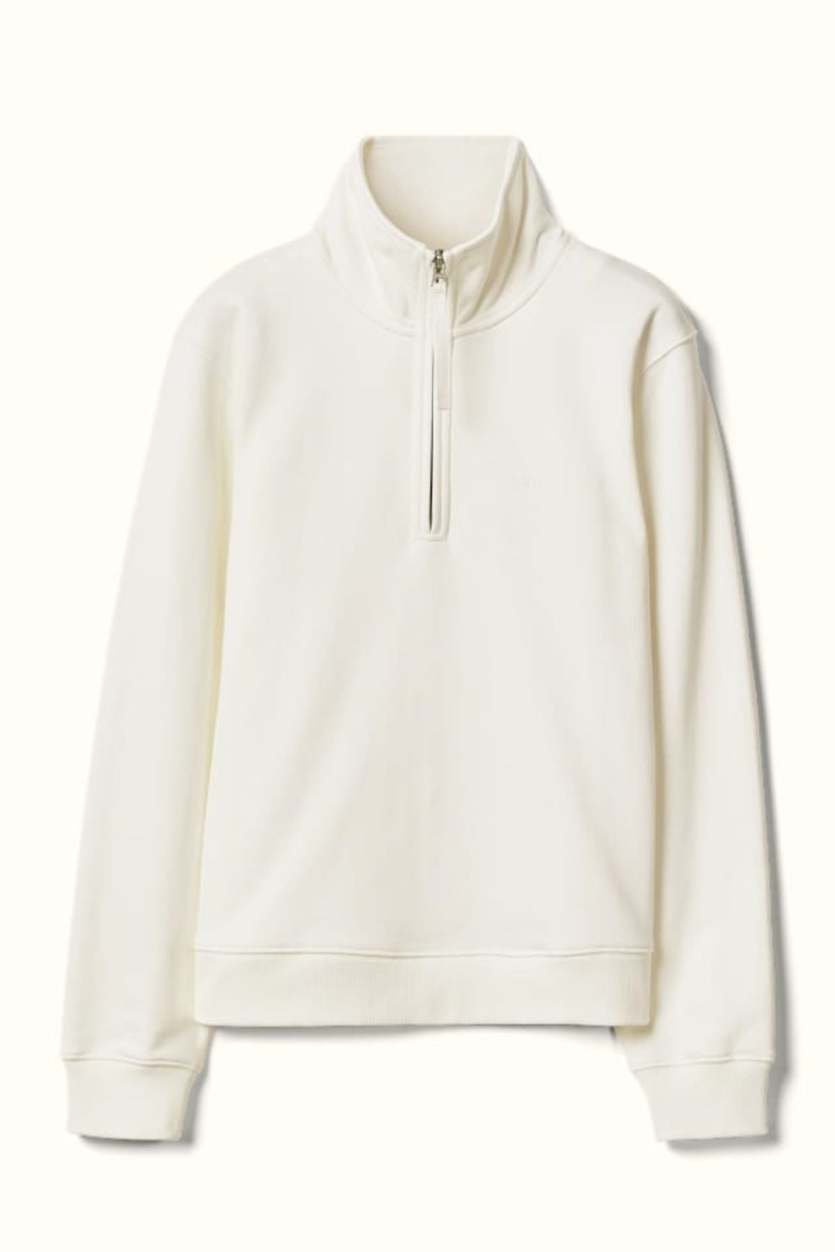 The RM Williams Trickett Zip Neck Sweatshirt is a plain, long-sleeve off-white pullover made from organic cotton, featuring a high collar and a front quarter zip closure, shown against a light background.