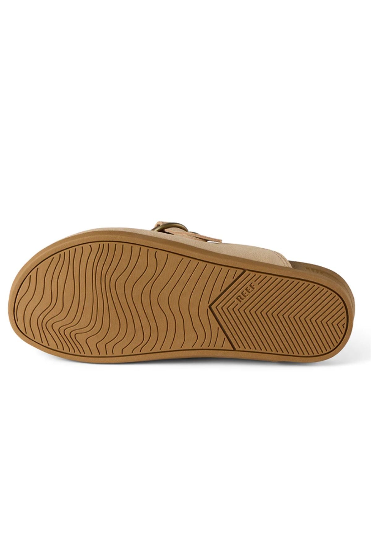 The image displays the bottom view of the REEF Vista Serenity sandal, highlighting its tan, textured rubber sole with wavy and diagonal tread patterns. The women's sandal features the "REEF" logo embossed on the sole for added branding.