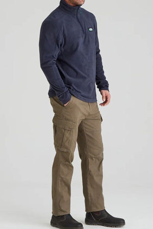 A person wearing the Ridgeline Narvik Fleece in navy, khaki cargo pants, and black boots stands against a plain light background.