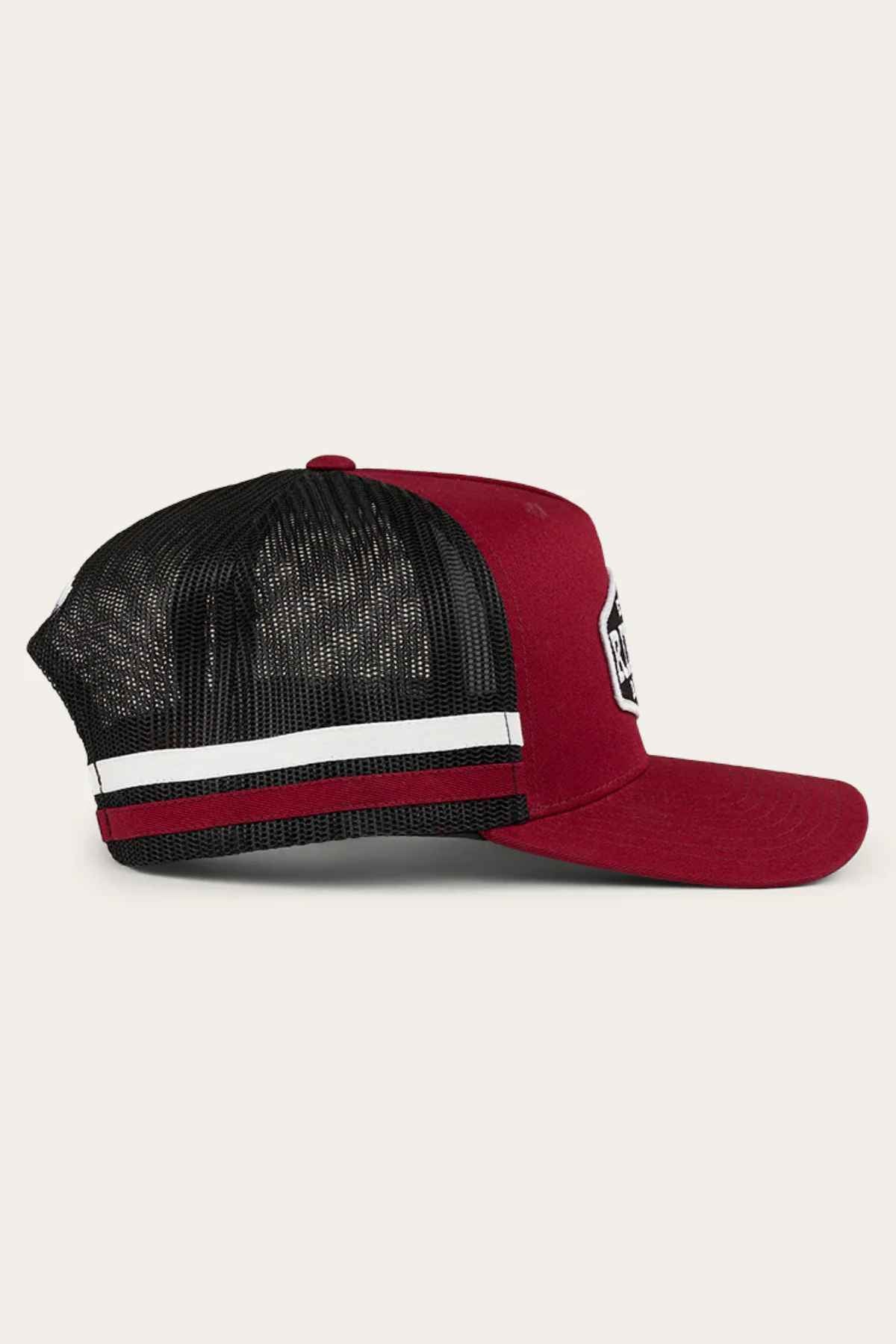 Here's a rewritten version using the given product data:

"This side view of the Ringers Western Banks Trucker Cap highlights its red and black mesh design, enhanced by a stylish white and black stripe. The cap features a solid red cotton twill front panel for durability, along with an adjustable snapback for comfort. A distinctive patch is prominently displayed on the front.
