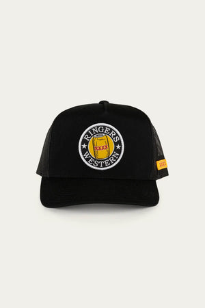 The Ringers Western Can Trucker cap features a twill front, poly mesh back for breathability, a circular patch with "Ringer's Western" and horse design on the front, and a yellow side tag.