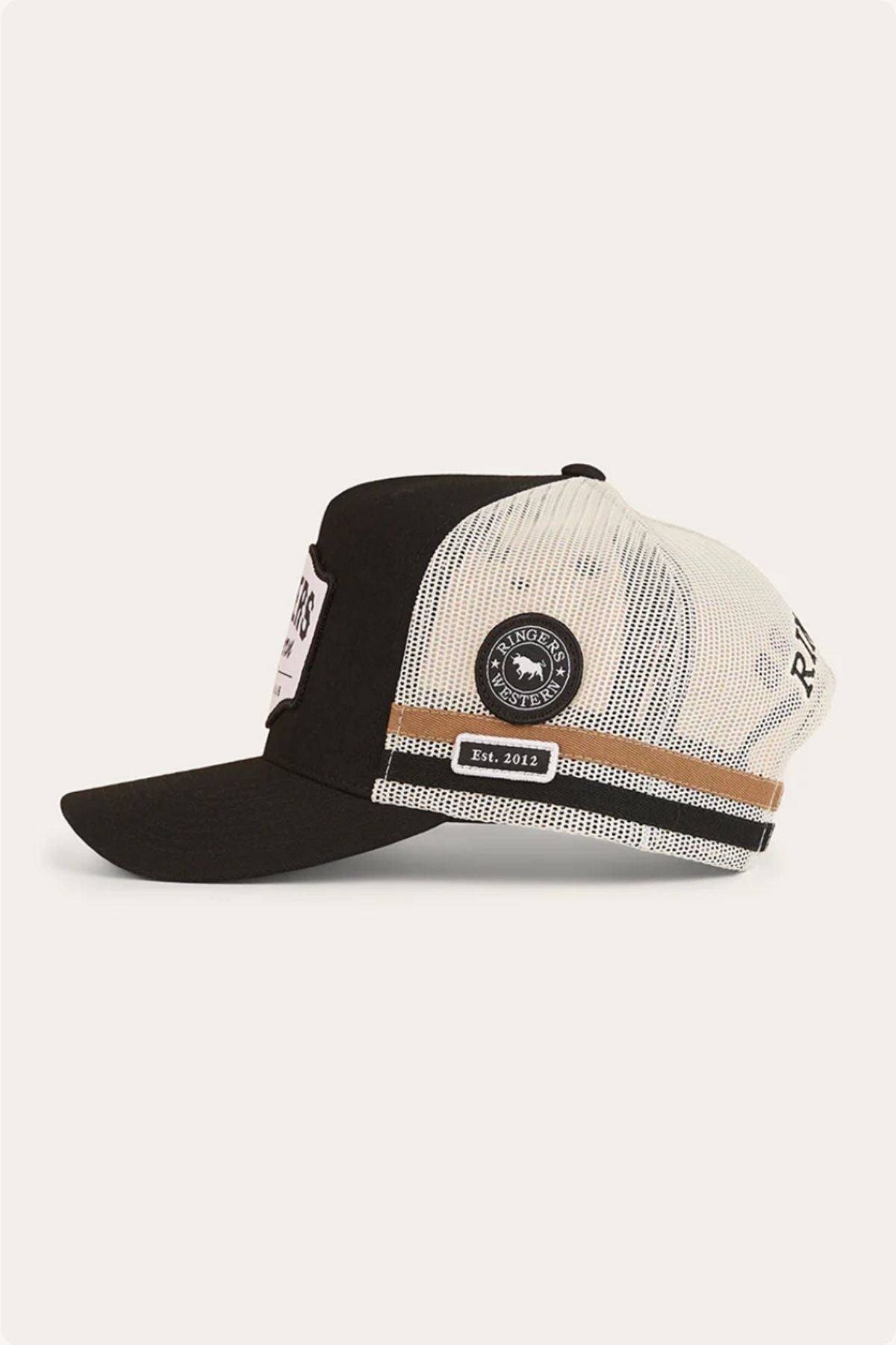 The Ringers Western Country Club Deep Fit Trucker Cap features a black and white colorway, round side patch, brown stripe detail, flat bill, and "RHODE" with "Est. 2013" labels—drawing inspiration from classic Country Club Trucker styles.