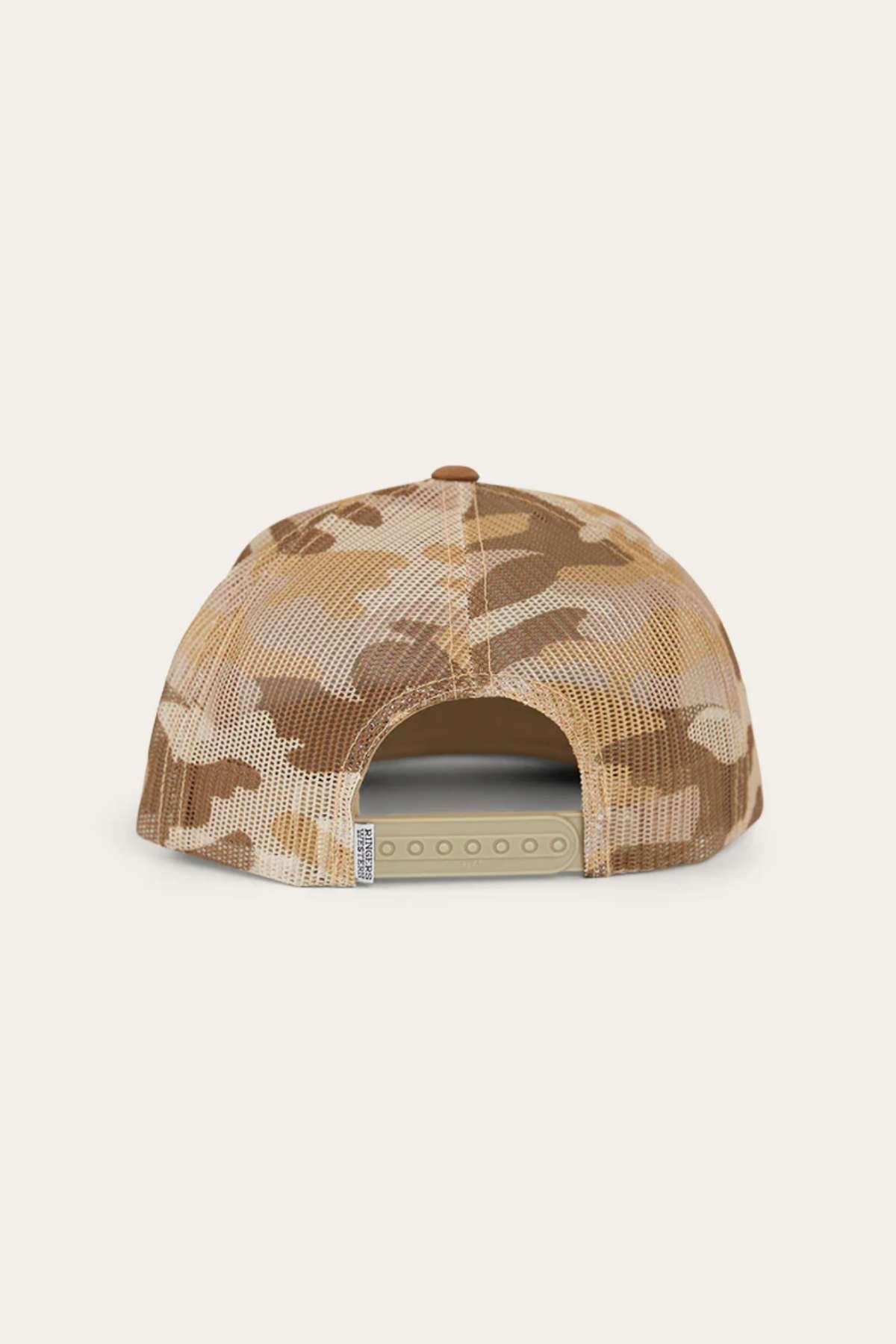 The Ringers Western Dalby Trucker Cap is shown from the back, displaying its tan and brown camo design with a cotton twill front, mesh panel, and adjustable snapback closure.
