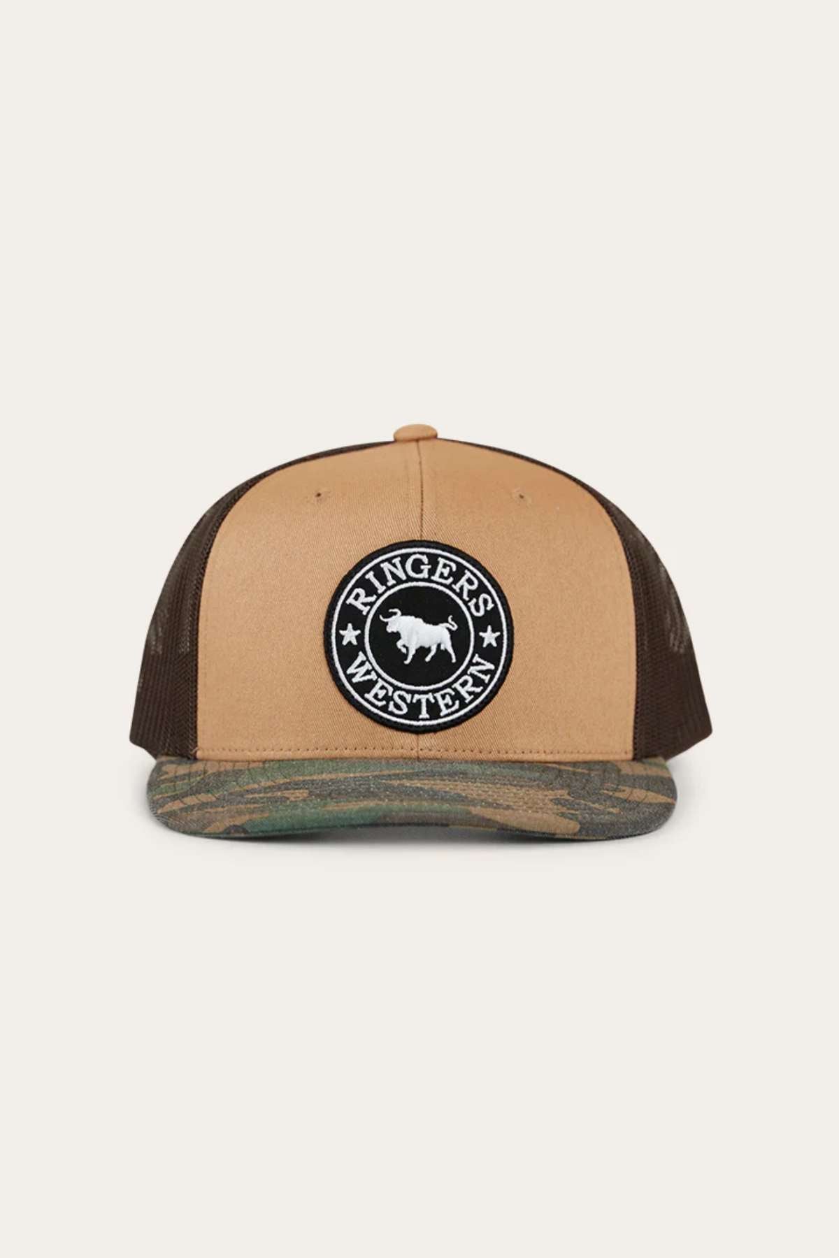 The Ringers Western Dalby Trucker Cap is a brown and black cap with a mesh back, snapback closure, and a circular patch displaying "Ringer's Western" with a bull silhouette. Its cotton twill brim has an eye-catching camouflage pattern.
