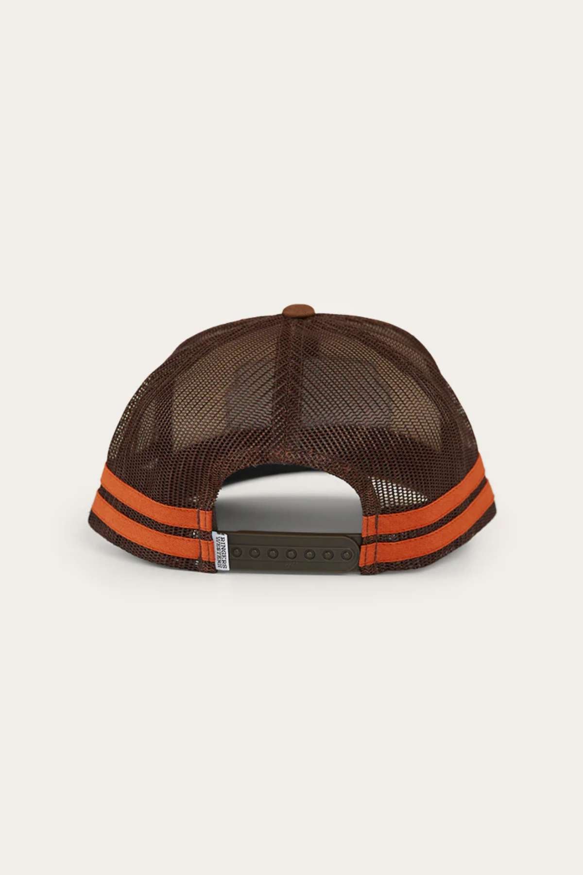 The Ringers Western Haulin Trucker Cap is shown from the back on a plain light background, featuring a brown mesh back, two orange stripes, and an adjustable snap closure.