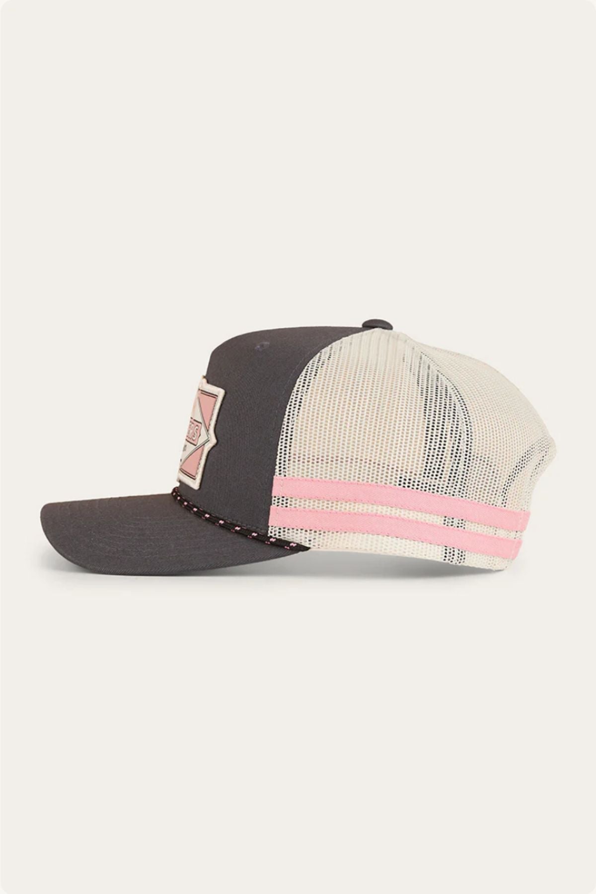 The Ringers Western Hometown Trucker Cap features a dark gray front, cream mesh back, pink and cream front patch, pink stripe detail, and an adjustable snapback for a perfect fit.