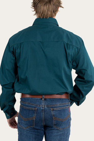 A person in a teal Ringers Western King River Half Button Shirt and blue jeans, viewed from behind against a plain light background.