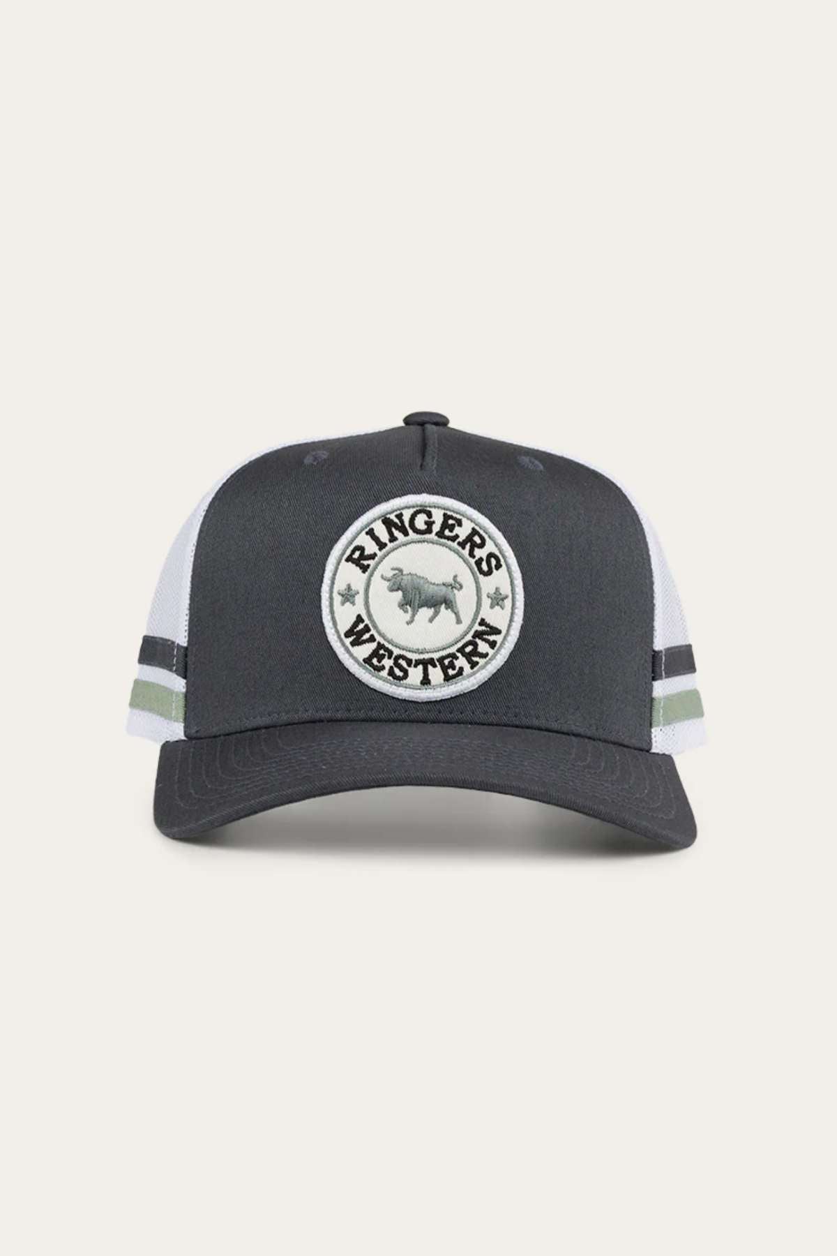 The Ringers Western McCoy Trucker Cap is a dark gray hat with a white mesh back, featuring a circular logo patch on the front that reads "RINGERS WESTERN" around the image of a bull. This stylish cap also includes two horizontal stripes on the sides of the mesh and is made from durable cotton twill for added comfort and style.