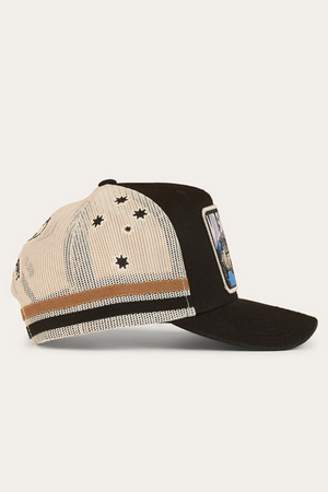 The Ringers Western Mud Sweat Beers Deep Fit Trucker Cap is black and white mesh with star designs, two brown side stripes, and a front rectangular patch graphic. Shown in side profile view.