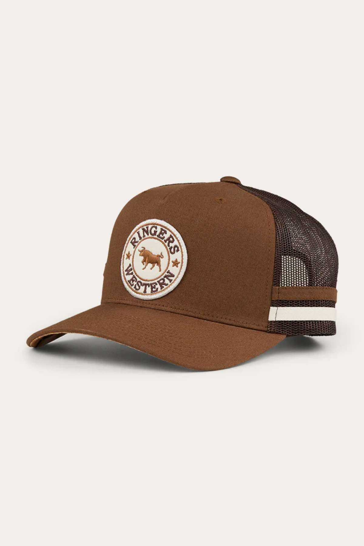 The Ringers Western Pendleton Trucker Cap is a brown trucker cap with a rounded bill and a mesh back. The front panel features an embroidered circular patch with a bull and the text "Ringers Western." This adjustable snapback cap also boasts brown and white striped accents on the side.