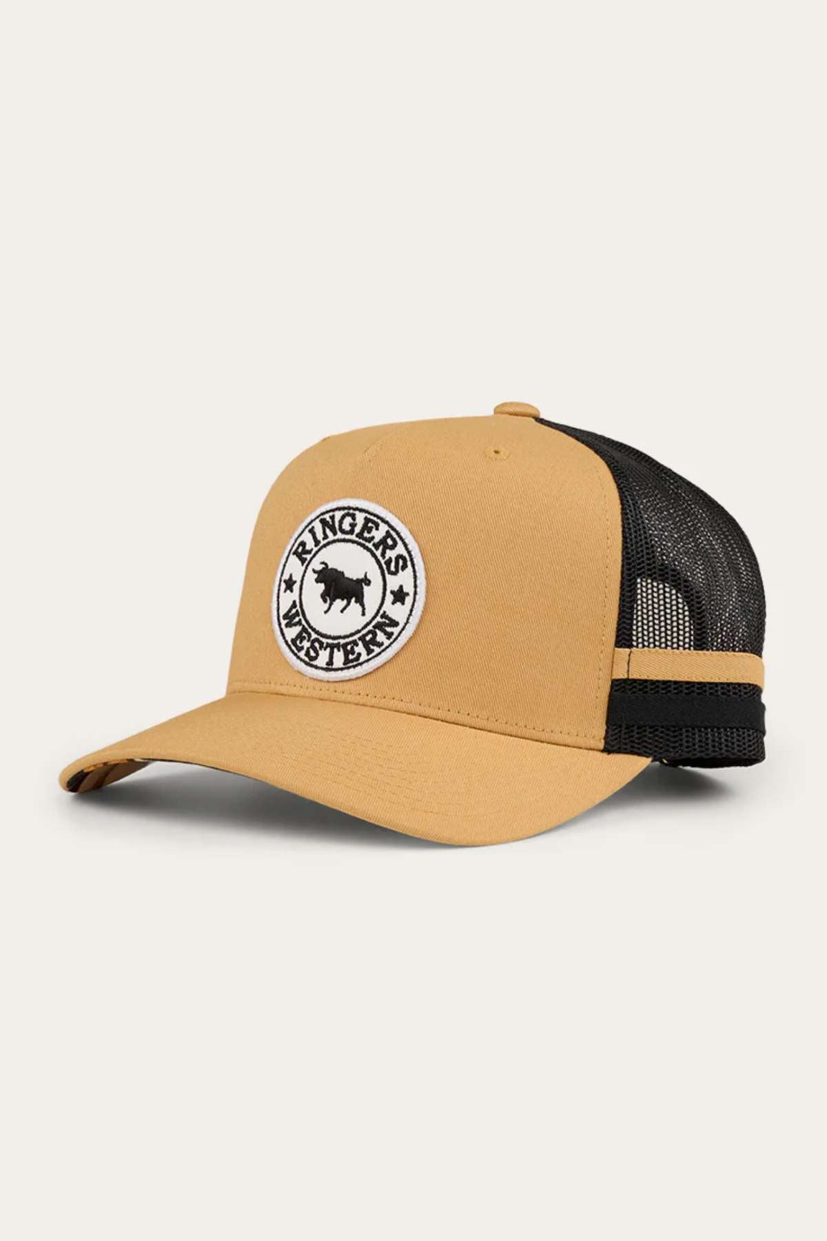 The Ringers Western Pendleton Trucker Cap is a tan and black hat with a curved brim. It features an embroidered badge on the front, depicting a black bull silhouette encircled by the text "Ringers Western." The back is made of black mesh with an adjustable snapback strap for a perfect fit.