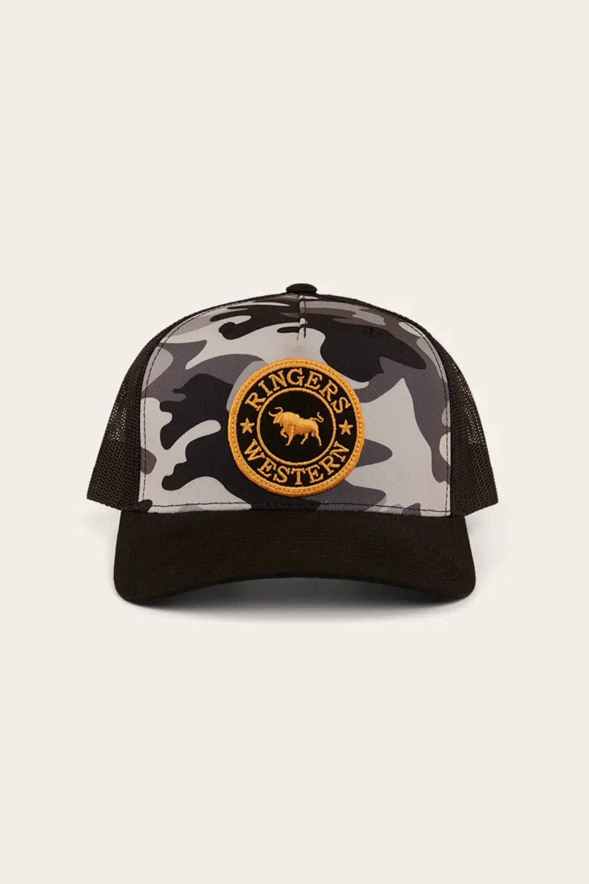 The Ringers Western Signature Bull Trucker Cap features a camouflage cotton twill front, black mesh back and brim, and a circular orange patch displaying a bull and the text "RINGER'S WESTERN.