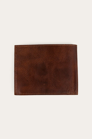 The Ringers Western Toro Grande Wallet, a closed brown full grain leather piece with a textured surface, is photographed against a plain light background.
