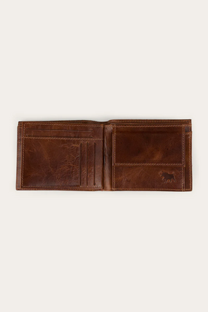The Ringers Western Toro Grande Wallet, crafted from full grain leather, features multiple card slots on the left and a coin pocket on the right. Displayed against a plain light background, it blends classic style with daily functionality.