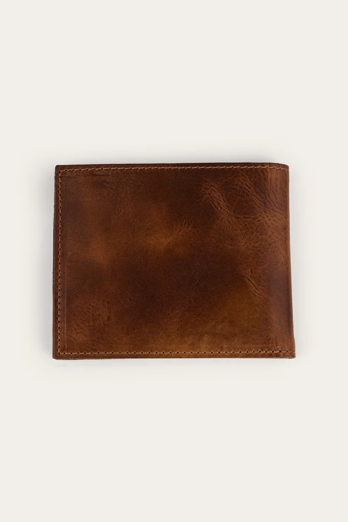 The Ringers Western Toro Midi Wallet, crafted from closed, brown full-grain leather with visible stitching, rests on a plain light background and showcases its slim, everyday-ready design.