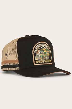 The Ringers Western Workhorse Trucker Cap is black and beige with mesh sides, a vibrant truck patch reading "WORKHORSE OF THE OUTBACK RINGERS WESTERN," star accents on the mesh, and an adjustable snapback for the ideal fit.