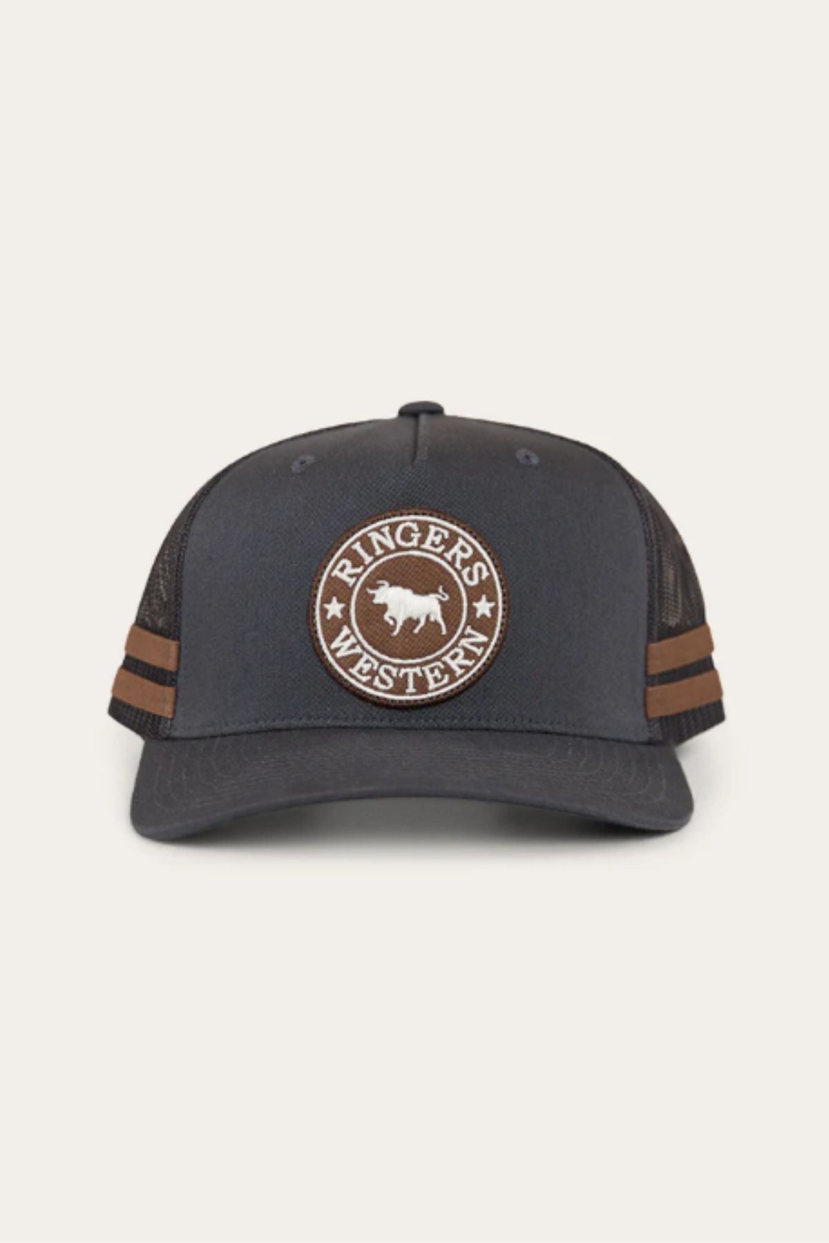 The Ringers Western McCoy Trucker Cap is a dark grey snap-back with a mesh back, brown side stripes, and a front circular patch that says "RINGER'S WESTERN" around a bull image.