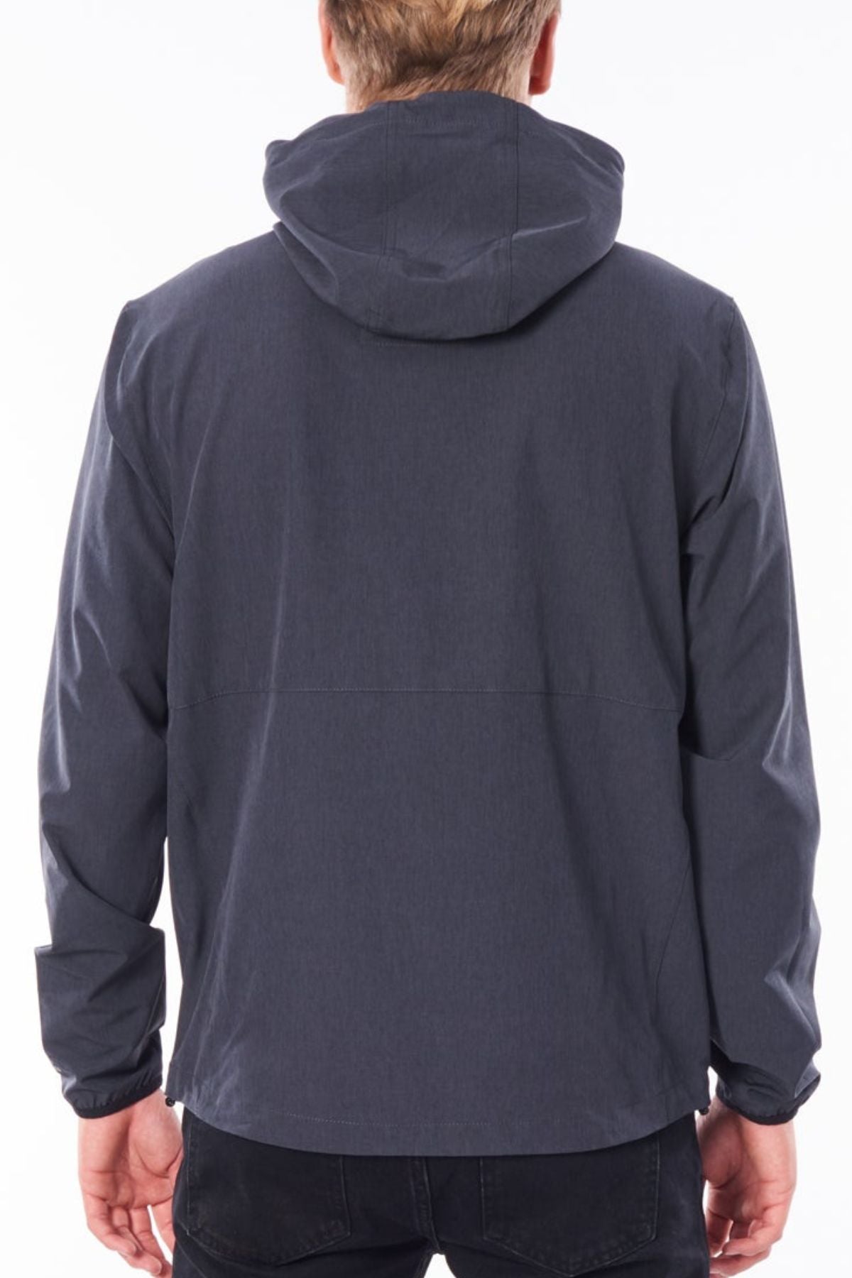 Seen from behind against a plain white background, a light-haired person wears the Rip Curl Anti Series Elite Jacket in dark gray with black pants.