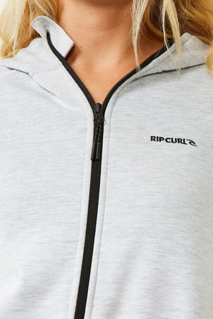 Close-up of a person wearing the Rip Curl Anti Series Flux III Zip hoodie in light gray, featuring bonded polar fleece, a black zipper, and the Rip Curl logo on the left chest. Only the lower face and upper torso are shown.