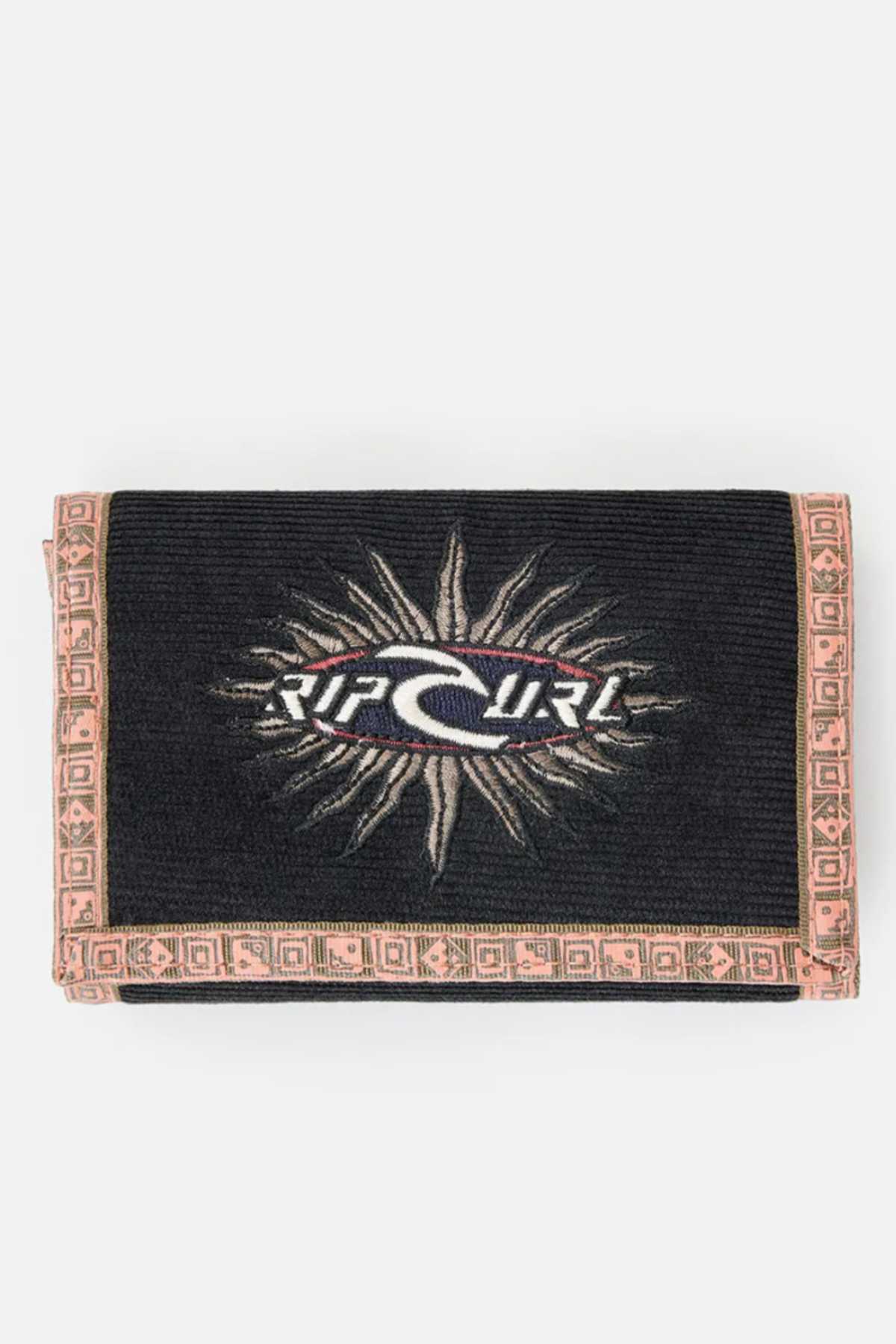 A black Rip Curl Archive Cord Surf Wallet features a white wave and sunburst logo on the front. The corduroy material is accented with a light beige woven border showcasing geometric patterns, and the brand name "Rip Curl" is prominently displayed in the center.