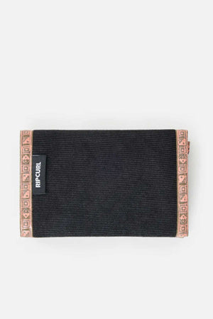 A black wallet with brown decorative accents along the top and bottom edges. The white-background beach wallet, part of the Rip Curl Archive Cord Surf Wallet collection, features a small black tag with the brand name "Rip Curl" in white letters on the front.