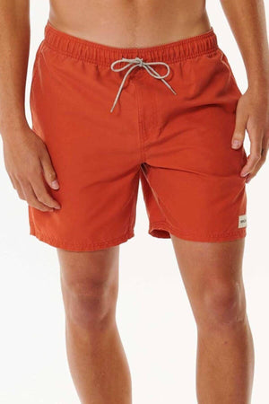 Against a white background, someone wears vibrant orange Rip Curl Bondi Volley board shorts featuring a white drawstring and a label on the left leg. Made from recycled PET, their arms are relaxed by their sides.