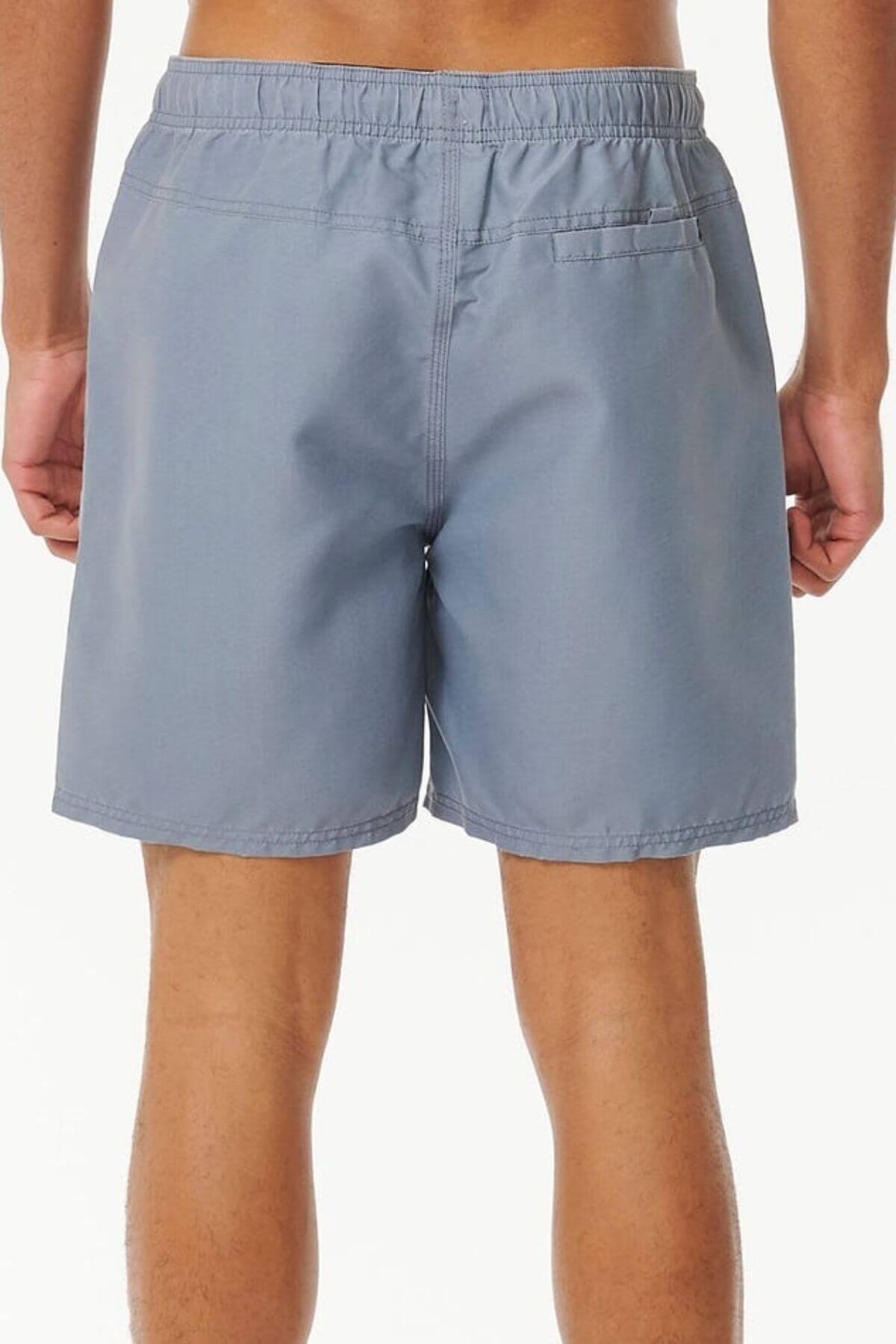 A person is shown from the waist down wearing light gray Rip Curl Bondi Volley board shorts with an elastic waistband and a back pocket, made from recycled PET, set against a plain white background.