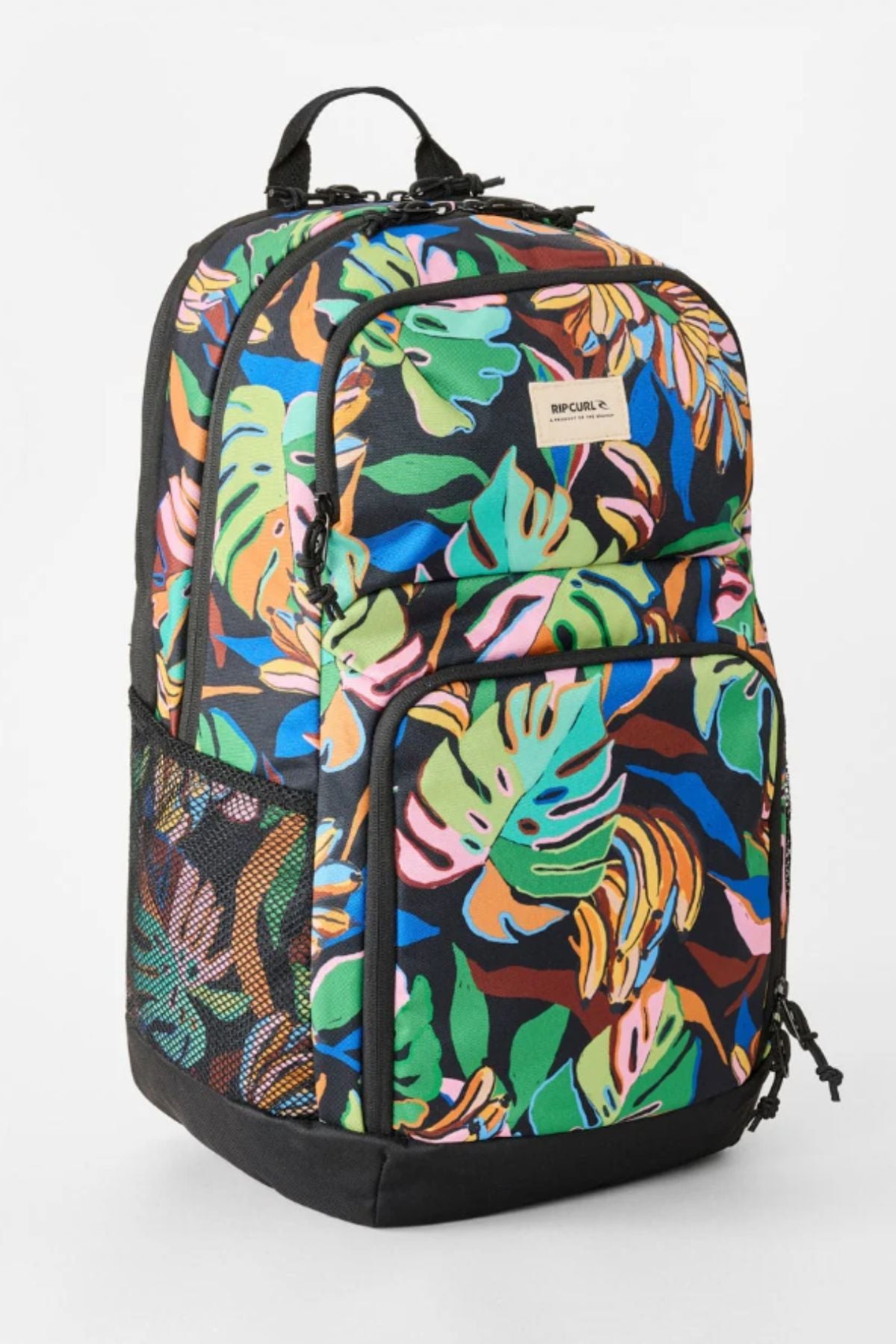 The Rip Curl Chaser 33L Backpack showcases a vibrant tropical leaf print in green, blue, orange, and pink. Made from recycled polyester, it includes multiple zippered compartments, black mesh side pockets, and a convenient top handle.