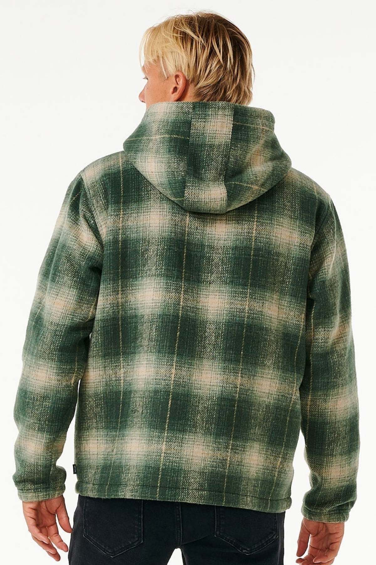 A person with blonde hair is seen from behind, wearing the Rip Curl Classic Surf Check Jacket with a sherpa-lined hood and dark jeans, set against a plain light background.