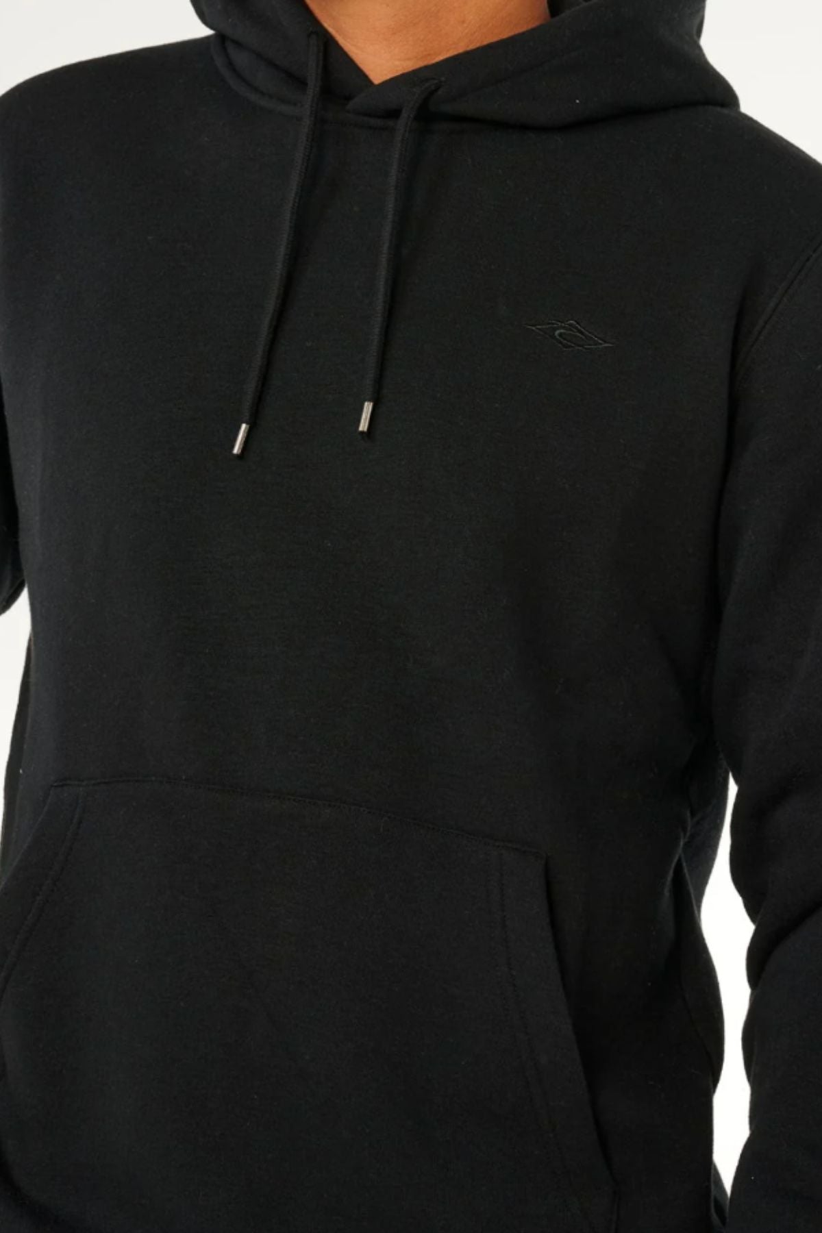 Model wearing the Rip Curl Classic Surf Hood in plain black with a front pocket and drawstrings, shown from shoulders to waist against a neutral background. The face is not visible.