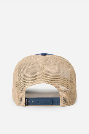 The Rip Curl Custom Curve Trucker is a beige cotton twill hat with a mesh back, blue adjustable snapback closure, curved peak, and a small black tag on the left side, shown from behind.