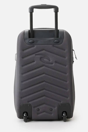 A gray rolling suitcase made from recycled polyester showcases a zigzag pattern on the front, with a telescopic handle and two wheels. Inspired by the Rip Curl F-Light 45L Classic Surf Transit Bag, it combines style with sustainability.
