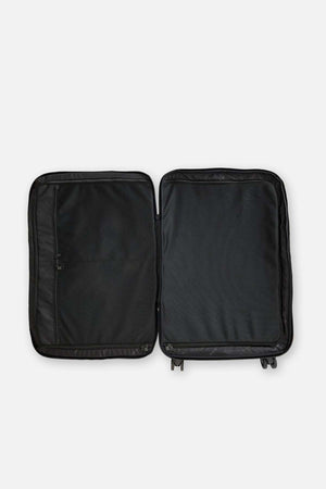 The Rip Curl F-Light 90L Check-In Wheeled Travel Bag is shown open on a white background, revealing two empty compartments—one with a zippered mesh pocket, the other with a solid fabric cover.
