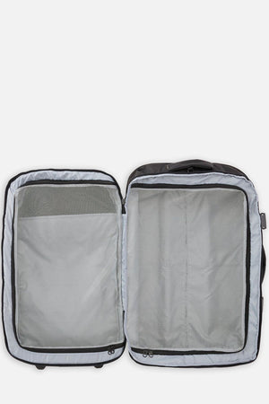 The Rip Curl F-Light Global 100L roller bag, open and empty, features a light gray interior with mesh zippered compartments on both sides, lying flat against a white background.