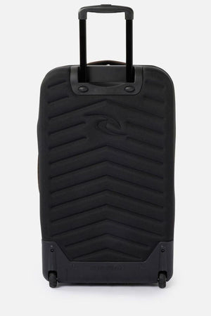 The Rip Curl F-Light Global 100L Search Travel Bag is a black travel suitcase with a hard shell and a zigzag texture. It includes a retractable handle, two wheels, and is made from recycled polyester, all set against a plain white background.