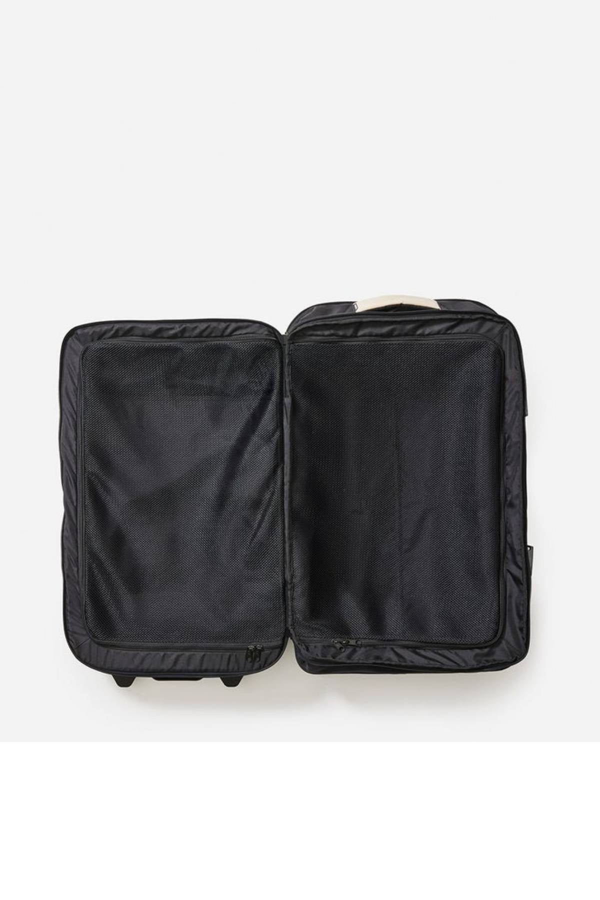 The Rip Curl F-Light Global 100L Soleil Travel Bag is open and empty against a white background, flaunting its interior lined with recycled polyester. Compression straps crisscross the spacious black suitcase, keeping contents secure for your adventures.