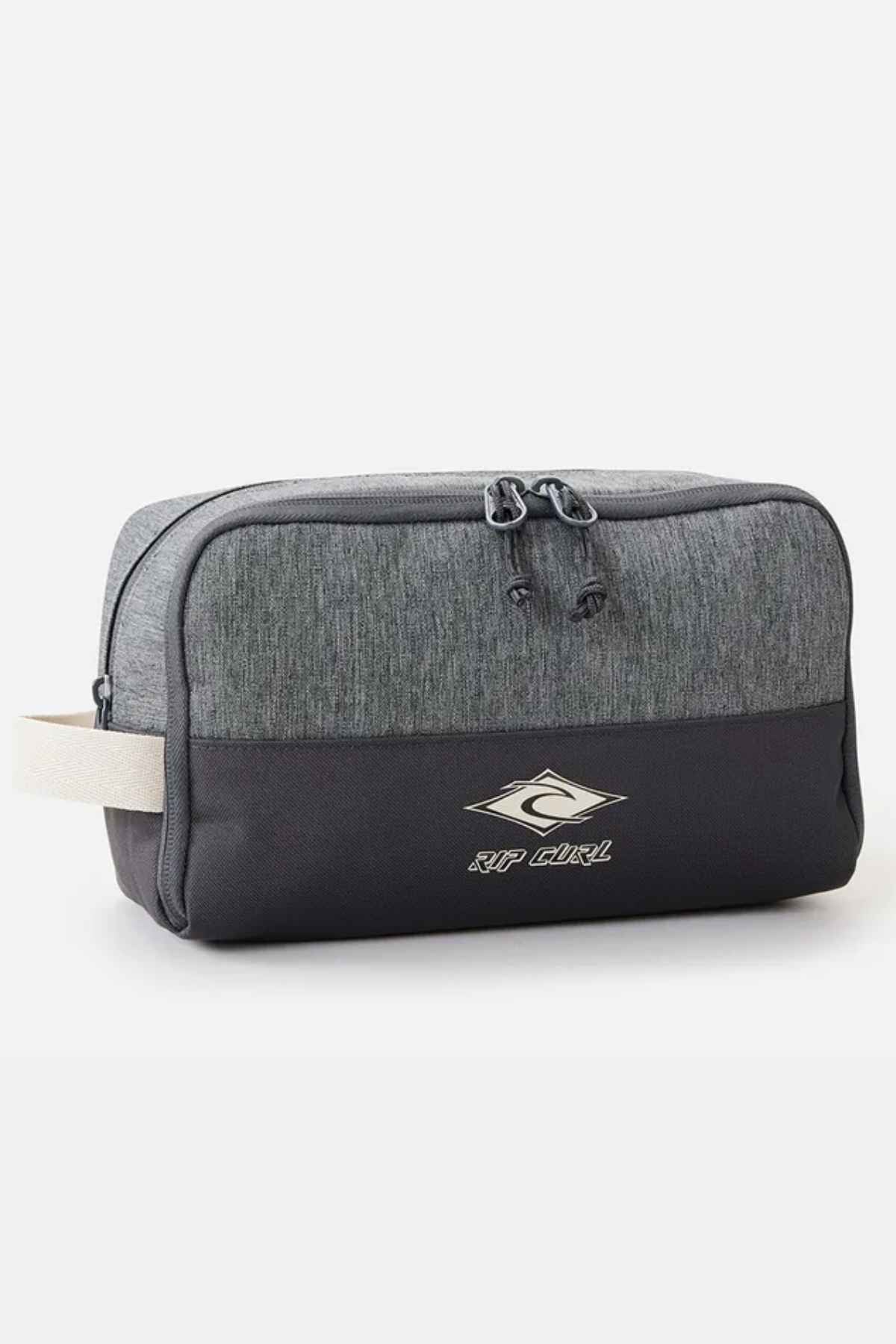 The Rip Curl Groom Classic Surf Toiletry Bag is made from eco-friendly textured fabric and showcases a sleek gray and black design with a logo on the front. It includes a handy side handle and has a secure zipper closure on top.