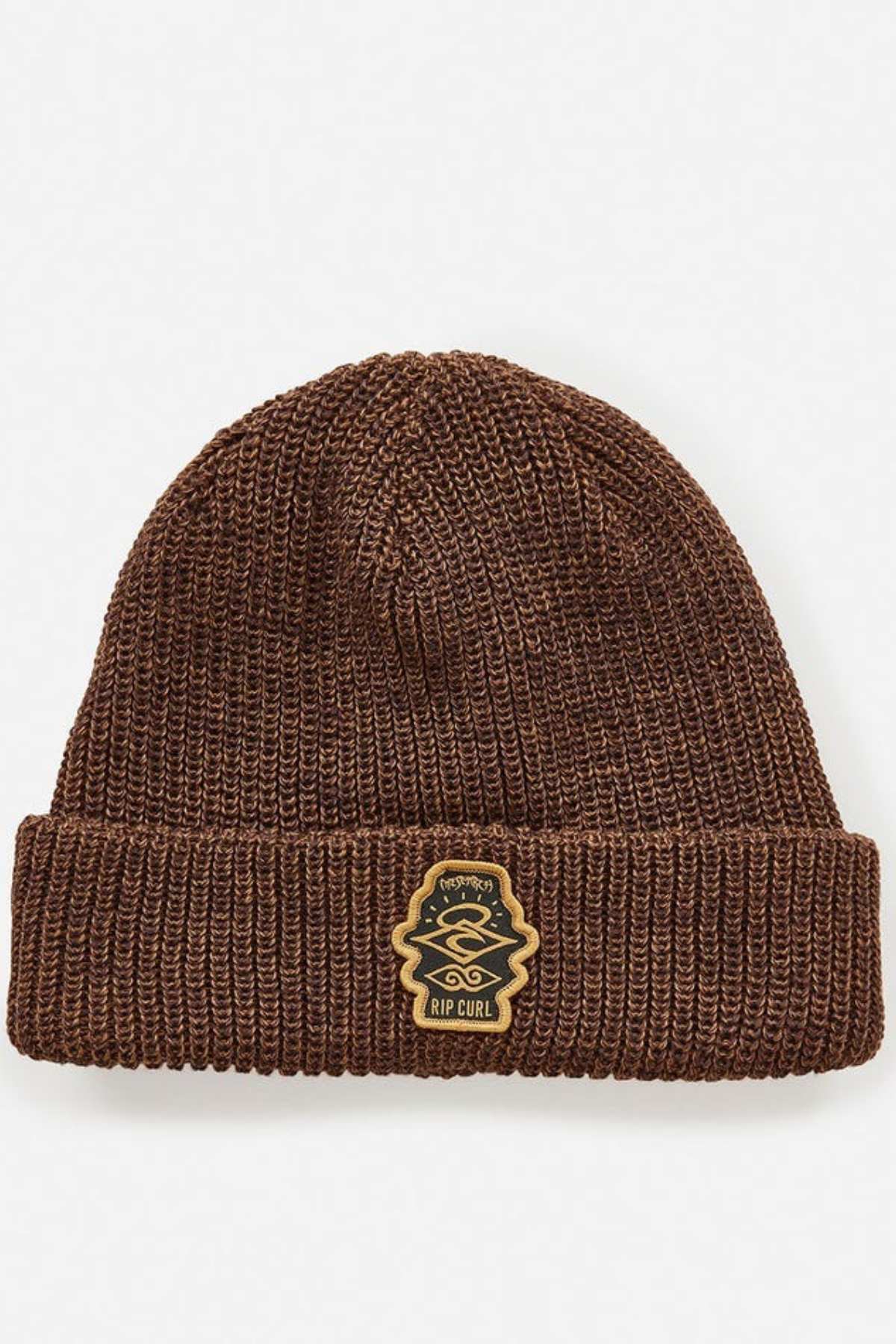 The Rip Curl Icons Reg Beanie, crafted from recycled polyester, boasts a brown knit design with a fold-over cuff and a sewn-on patch featuring the beige and black "RIP CURL" emblem. Ideal for outdoor adventures, this beanie is elegantly showcased against a plain white background.