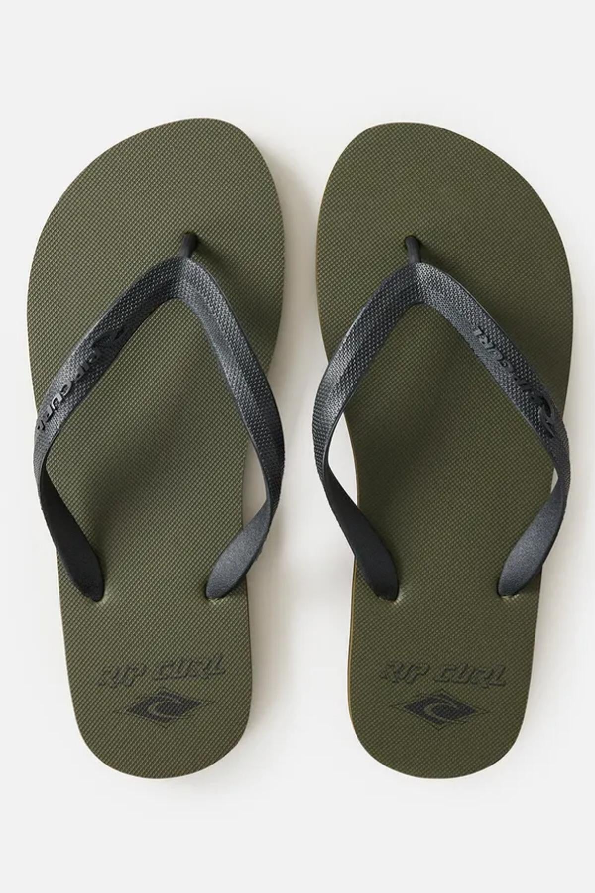 A pair of Rip Curl Icons of Surf Bloom Thongs in olive green with dark gray straps. The straps have a subtle texture, and the soles feature a small logo near the heels. The thongs are positioned side by side on a plain white background.