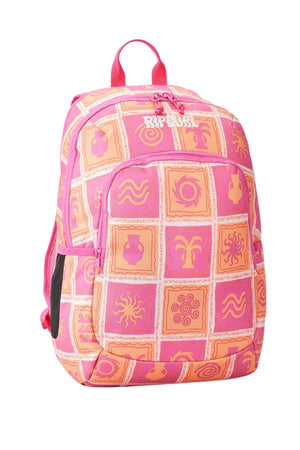 The Rip Curl Ozone 2.0 30L Backpack is a pink and orange school backpack featuring a tile pattern with suns, waves, and plants. Made from recycled fabric, it includes a front pocket and top handle and prominently displays the "Rip Curl" logo on its upper section.