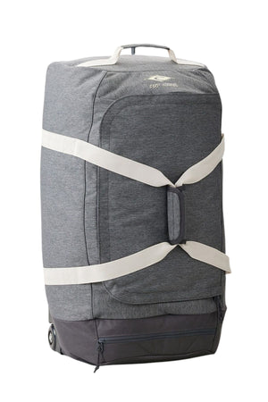 The Rip Curl Jupiter 80L Classic Surf Travel Bag is a spacious, grey duffel with wheels and a retractable handle. It showcases white crisscross straps along with the logo on top, while the bottom part is in a darker shade of grey. Lightweight and eco-friendly, it stands upright against a white background.