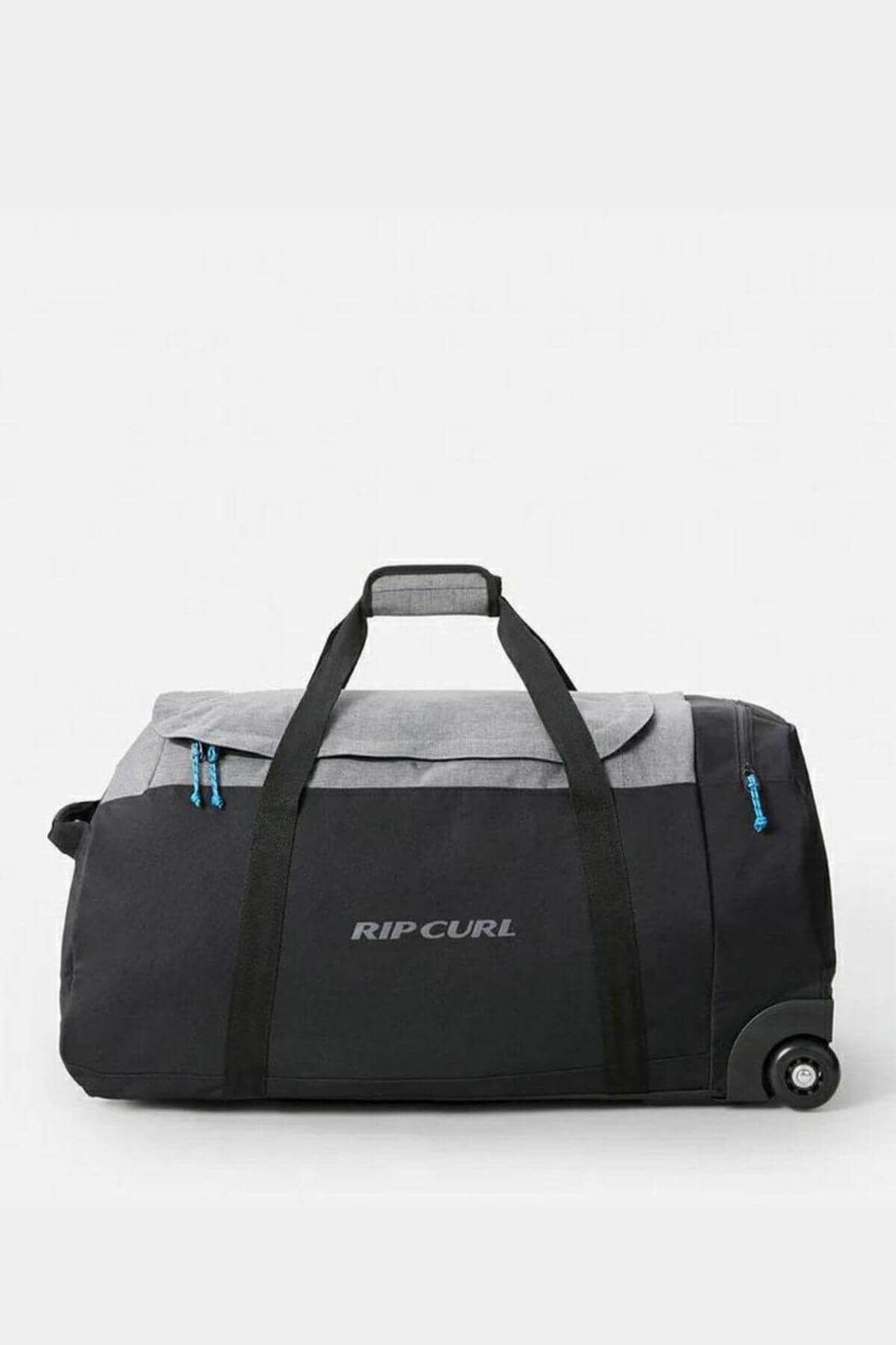 The Rip Curl Jupiter 80L IOS Bag is a spacious black and gray rolling duffle with the brand's logo on the side. It features two wheels, a sturdy handle for easy transport, blue zippers, and is made from durable water-resistant ripstop material.