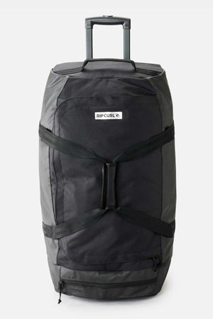 A large Rip Curl Jupiter 80L Icons Travel Bag in black features a telescopic handle. Crafted from recycled polyester, it includes multiple straps and zippers, a shoe pocket, and a small logo patch on the front.