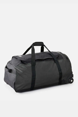 The Rip Curl Jupiter 80L Icons Travel Bag is a spacious black and dark gray duffle made from recycled polyester fabric. It has two sturdy handles, a small side zippered compartment, a shoe pocket, and wheels with a telescopic handle for effortless rolling, making it perfect for travel.